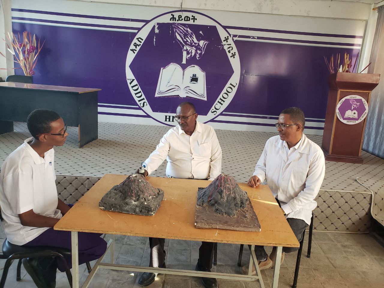 Students demonstrating a volcano model at a science exhibition