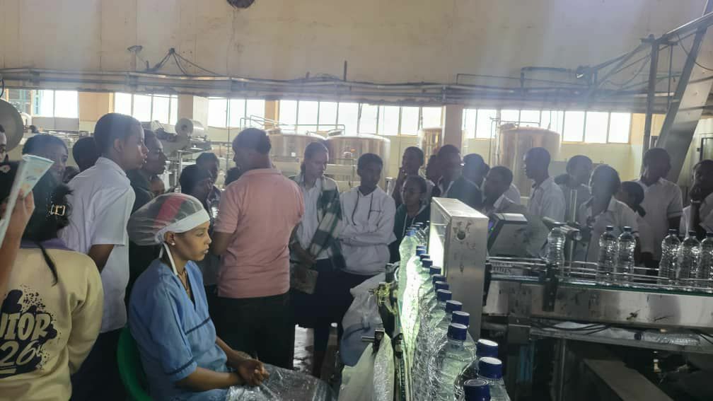 Students touring a water bottling factory