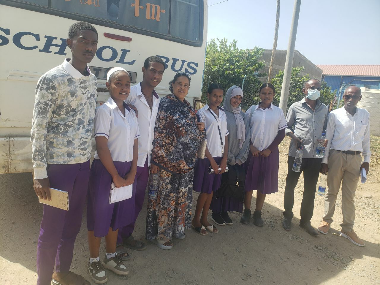 Students with the school bus before a field trip